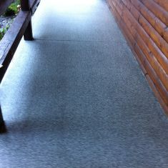 Coated sidewalk with added slip resistance for exterior sidewalk